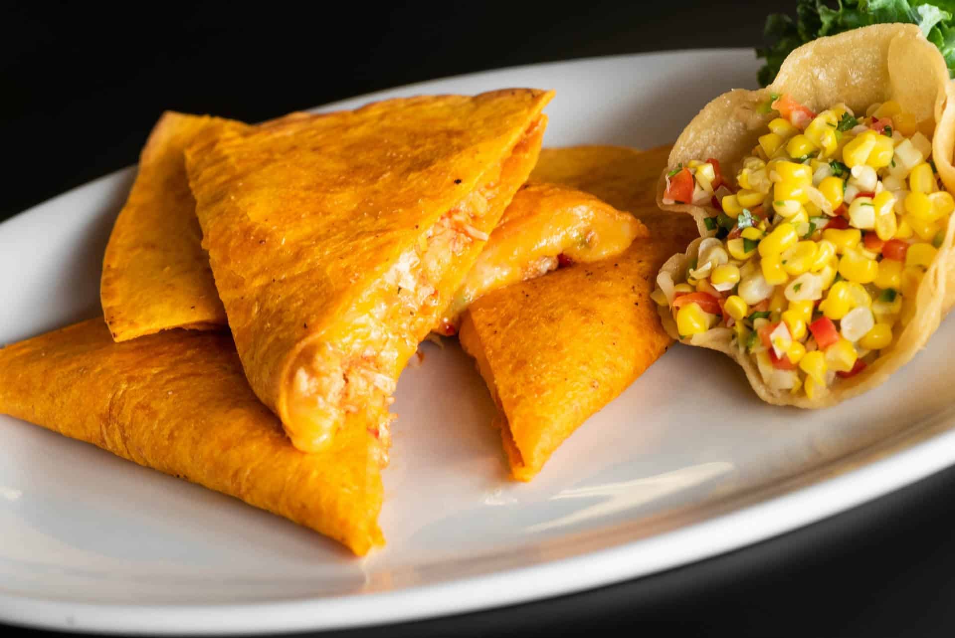 Fresh shrimp tacos with colorful salsa at The Original Island Shrimp House. Shrimp tacos with salsa on a white plate, showcasing fresh seafood and vibrant flavors.