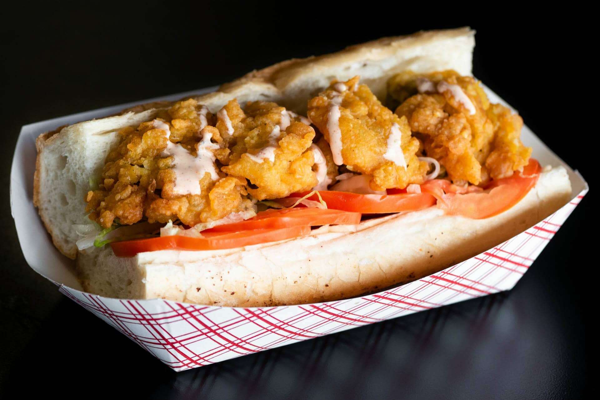 The Original Island Shrimp House Shrimp Po' Boy sandwich with crispy fried shrimp and fresh vegetables.