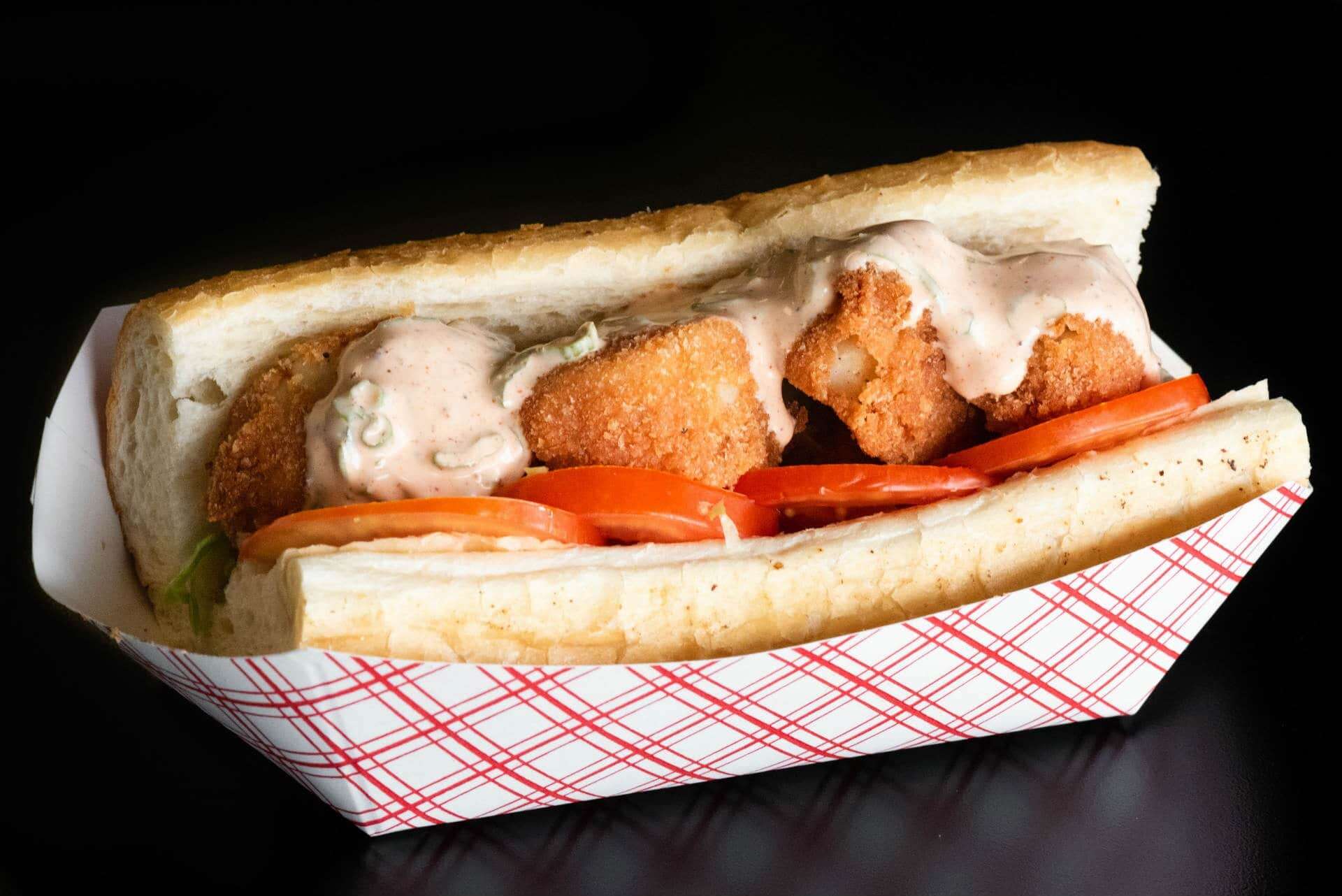 The Original Island Shrimp House Fresh fried shrimp sandwich with tomatoes and sauce on a bun, served at The Original Island Shrimp H.