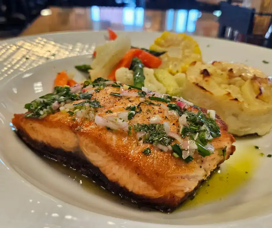 Fresh grilled salmon served with vegetables and mashed potatoes at The Original Island Shrimp House.